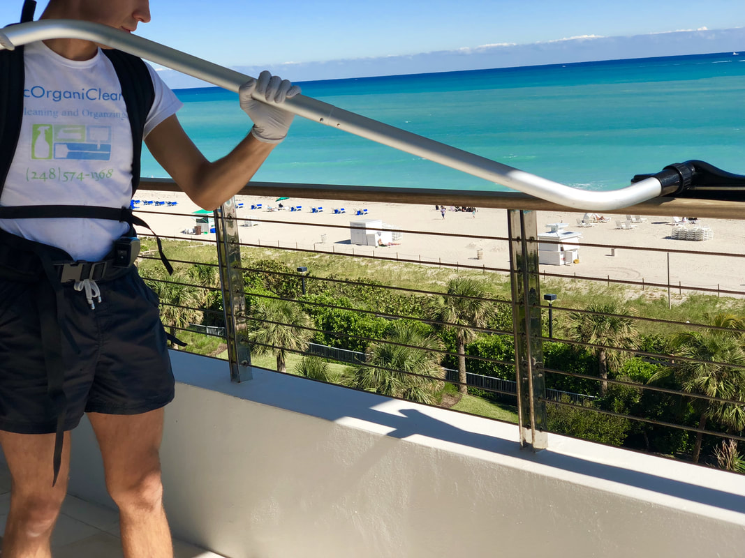EcOrganiClean team cleaning a beachfront balcony in Miami